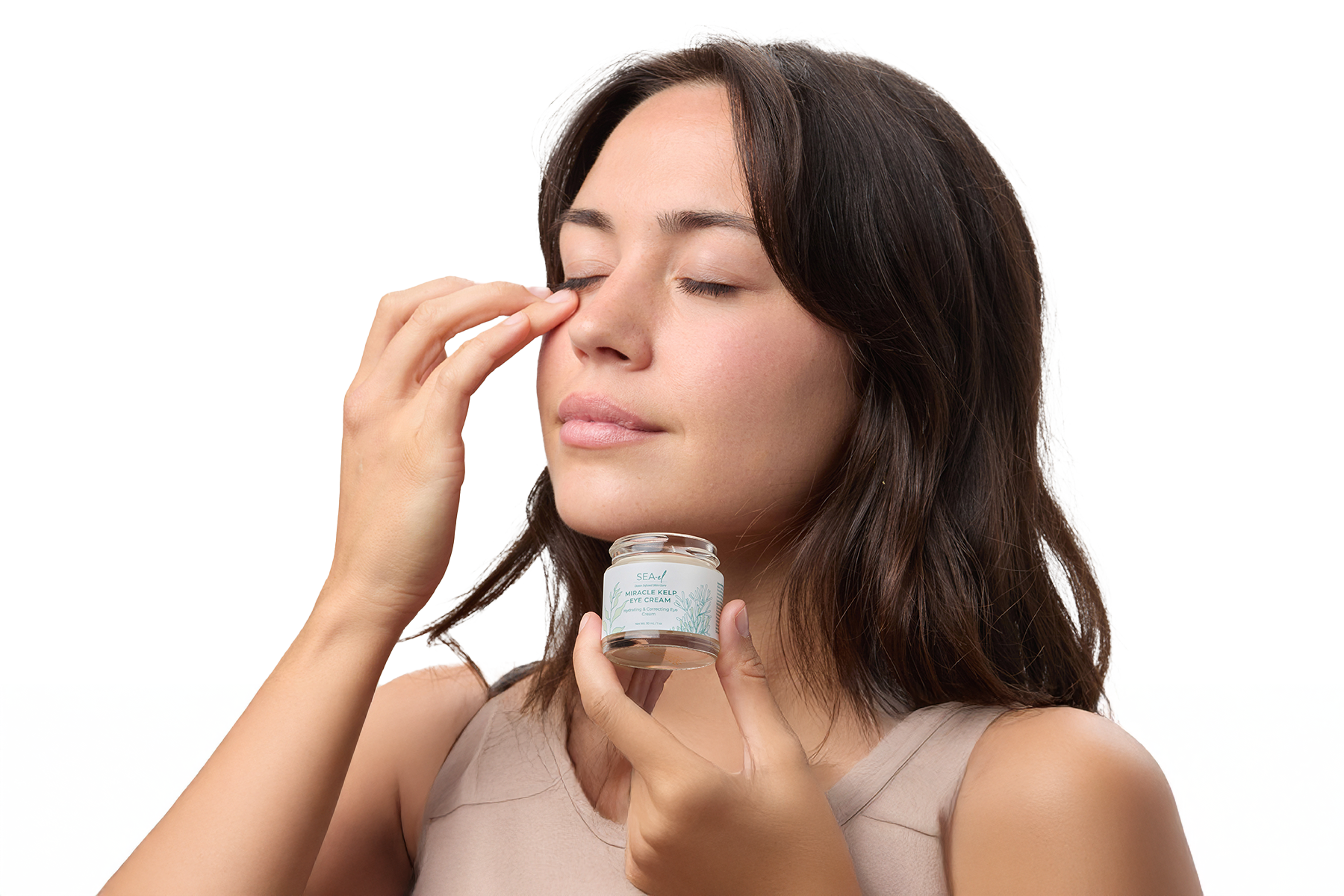 Image of a girl applying an eye cream around her eye area.