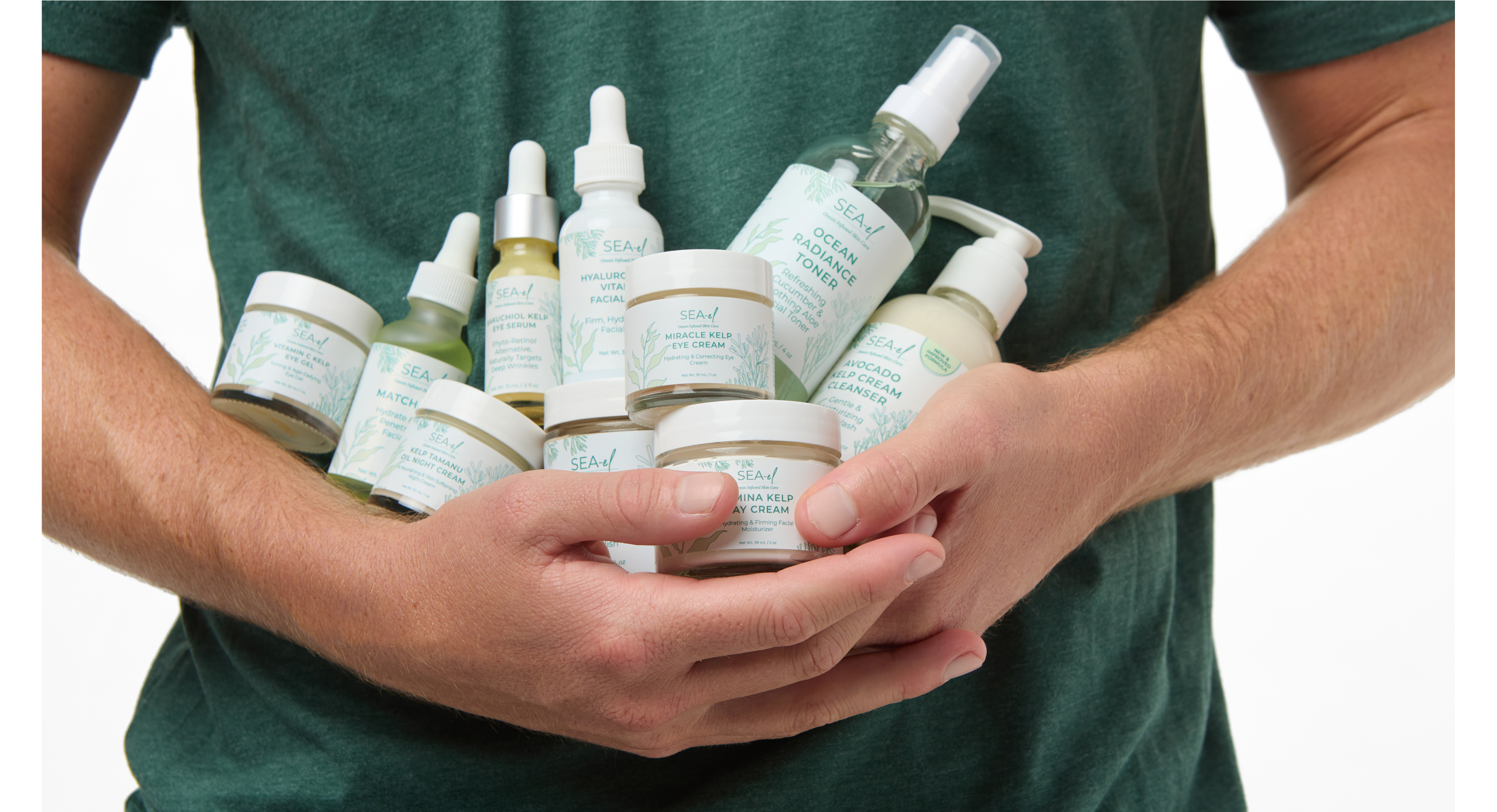 Man holding a ton of products from Sea el Skincare.