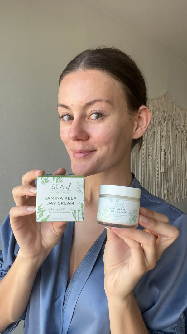 Image of a girl holding our Day cream in her robe.