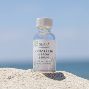 Image of a castor lash bottle on the beach.