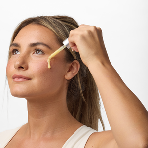 Image of girl applying our Hyaluronic Acid Vitamin C Serum on her face.