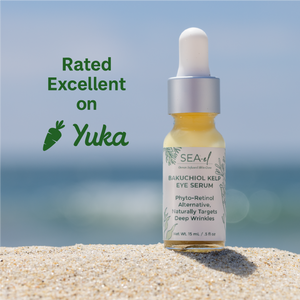 Bottle of Sea El Bakuchiol Kelp Eye Serum on sand with ocean background and 'Yuka' rating text.