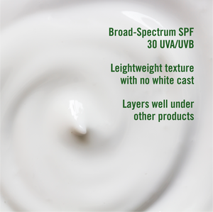 Close-up of a white cream with green text detailing SPF and texture properties.