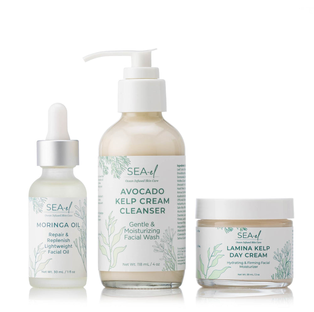 A set of three skincare products from Sea el Skincare including a facial cleanser, a day cream, and an antioxidant oil, all with natural ingredients emphasized on the labels.