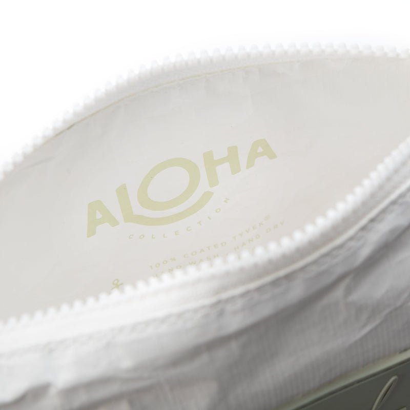 A white cosmetic bag with a leaf pattern, featuring a label with the brand name 'Sea el Skincare inside the bag.