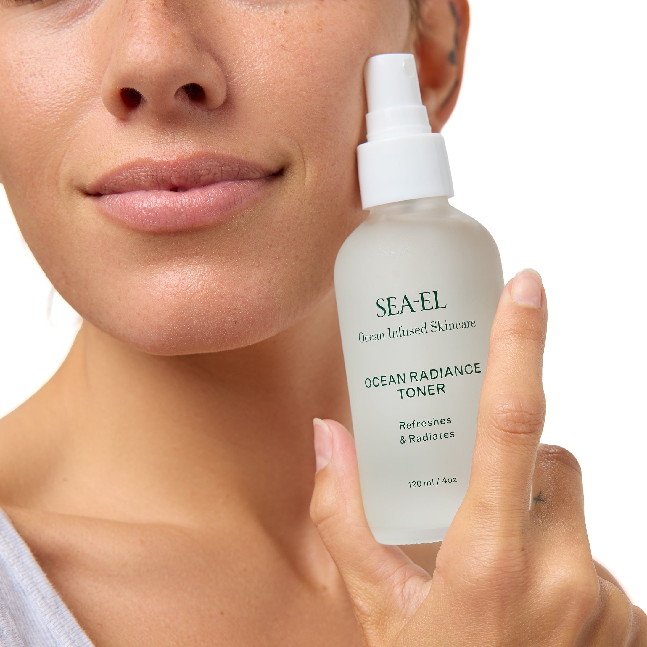 Girl holding Toner next to her face with a smile.