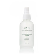 SEA-EL Ocean Radiance Toner in a frosted white spray bottle with a white pump dispenser, set against a clean white background with a subtle reflection.