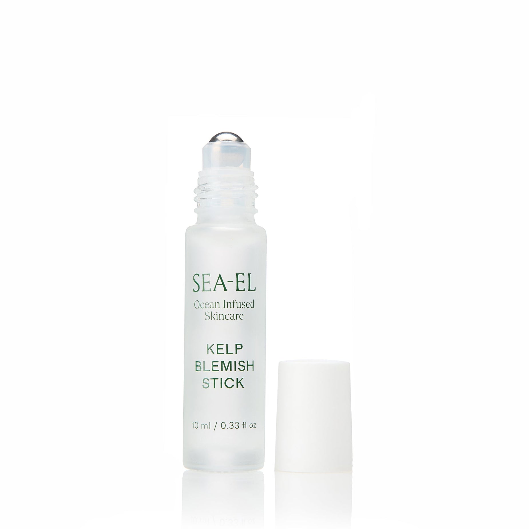 A small cylindrical bottle of SEA-EL Kelp Blemish Stick on a clean white background with a soft reflection below and the cap is off.